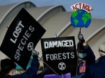 Demonstrators from Extinction Rebellion holds placards at a protest about Loss and Damage to the earth during the COP26 Climate Change conference in Glasgow, Scotland. (Image for represenation)(AP Photo) Demonstrators from Extinction Rebellion holds placards at a protest about Loss and Damage to the earth during the COP26 Climate Change conference in Glasgow, Scotland. (Image for represenation)(AP Photo)