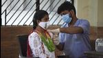 A health worker administers a dose of Covid-19 vaccine to a beneficiary at a community centre in Sukhrali Village near Iffco Chowk in Gurugram. (HT File) A health worker administers a dose of Covid-19 vaccine to a beneficiary at a community centre in Sukhrali Village near Iffco Chowk in Gurugram. (HT File)