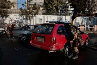 A Taliban fighter searches a car at a checkpoint in Kabul, Afghanistan (REUTERS)