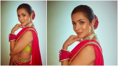 Malaika Arora teamed her saree with a parrot green sleeveless blouse with a low neckline. (Instagram/@malaikaaroraofficial)