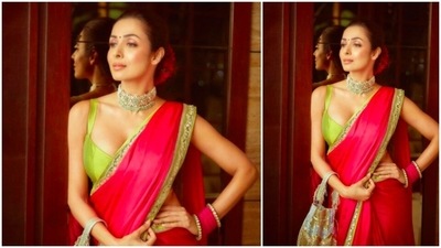For her hairdo, Malaika Arora pulled her hair back and tied a low neat bun. She added red flowers to her bun for the complete traditional look. (Instagram/@malaikaaroraofficial)