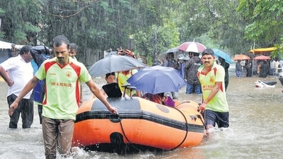 Tamil Nadu fire and rescue team during a rescue operation at a waterlogged area following heavy rain in Chennai on Sunday. (PTI)