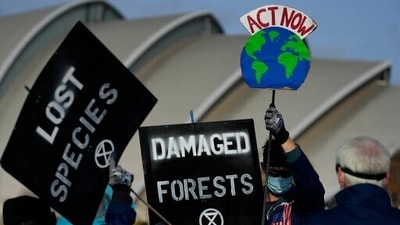 Demonstrators from Extinction Rebellion holds placards at a protest about Loss and Damage to the earth during the COP26 Climate Change conference in Glasgow, Scotland. (Image for represenation) (AP Photo) Demonstrators from Extinction Rebellion holds placards at a protest about Loss and Damage to the earth during the COP26 Climate Change conference in Glasgow, Scotland. (Image for represenation) (AP Photo)