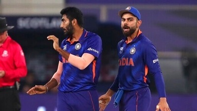 India's Jasprit Bumrah, left, celebrates the dismissal of Scotland's captain Kyle Coetzer with captain Virat Kohli during the Cricket Twenty20 World Cup match between India and Scotland in Dubai, UAE, Friday, Nov. 5, 2021.&nbsp; (AP)