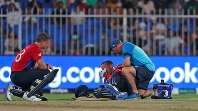 England's Jason Roy lies on the ground, attended to by a support staff after an injury during the Cricket Twenty20 World Cup match between England and South Africa in Sharjah, UAE, Saturday, Nov. 6, 2021.&nbsp; (AP)