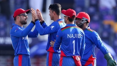Afghanistan's Mujeeb Ur Rahman, centre, is congratulated by teammates after taking the wicket of New Zealand's Daryl Mitchell during the Cricket Twenty20 World Cup match between New Zealand and Afghanistan in Abu Dhabi, UAE, Sunday, Nov. 7, 2021. (AP Photo/Kamran Jebreili) (AP) Afghanistan's Mujeeb Ur Rahman, centre, is congratulated by teammates after taking the wicket of New Zealand's Daryl Mitchell during the Cricket Twenty20 World Cup match between New Zealand and Afghanistan in Abu Dhabi, UAE, Sunday, Nov. 7, 2021. (AP Photo/Kamran Jebreili) (AP)