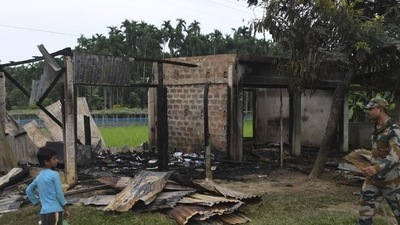 A paramilitary soldier patrols past a shop that was set on fire in Rowa village, about 220 kilometers from Agartala, in Tripura on October 26. (AP) A paramilitary soldier patrols past a shop that was set on fire in Rowa village, about 220 kilometers from Agartala, in Tripura on October 26. (AP)