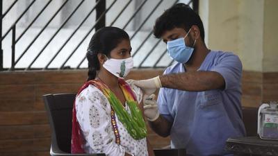 A health worker administers a dose of Covid-19 vaccine to a beneficiary at a community centre in Sukhrali Village near Iffco Chowk in Gurugram. (HT File) A health worker administers a dose of Covid-19 vaccine to a beneficiary at a community centre in Sukhrali Village near Iffco Chowk in Gurugram. (HT File)