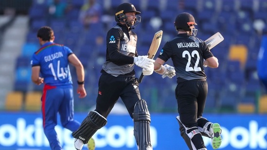 New Zealand's Devon Conway, left, runs between the wickets with teammate Kane Williamson, right, during the Cricket Twenty20 World Cup match between New Zealand and Afghanistan in Abu Dhabi, UAE, Sunday, Nov. 7, 2021. (AP Photo/Kamran Jebreili)(AP)
