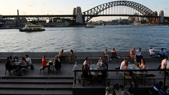 Patrons dine-in at a bar by the harbour in the wake of coronavirus disease (Covid-19) regulations easing, following an extended lockdown to curb an outbreak, in Sydney, Australia(REUTERS/Jaimi Joy/File Photo)