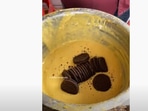 The image shows a few Oreo cookies in a batter.