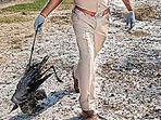 An officer carries the carcass of a demoiselle crane, in Kaparda village.