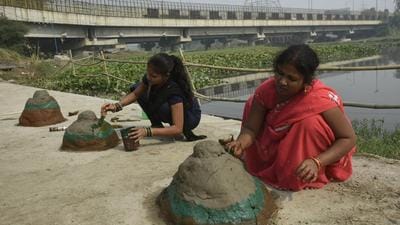 Devotees prepare mud structures for the Chhath Puja celebrations, near the Hindon river on Monday. (Sakib Ali/HT) Devotees prepare mud structures for the Chhath Puja celebrations, near the Hindon river on Monday. (Sakib Ali/HT)