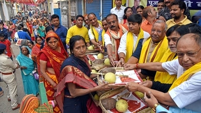 Bihar Deputy Chief Minister Tarkishore Prasad with Bharatiya Janata Party (BJP) leaders Ramkirpal Yadav and Sanjeev Chaurasiya distribute coconuts, sarees and other worship items on the first day of Chhath Puja in Patna.&nbsp; (ANI)