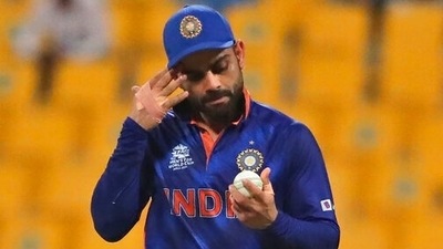 India's captain Virat Kohli holds the ball before handing it over to the next bowler during the Cricket Twenty20 World Cup match between India and Afghanistan in Abu Dhabi, UAE, Wednesday, Nov. 3, 2021. (AP) India's captain Virat Kohli holds the ball before handing it over to the next bowler during the Cricket Twenty20 World Cup match between India and Afghanistan in Abu Dhabi, UAE, Wednesday, Nov. 3, 2021. (AP)