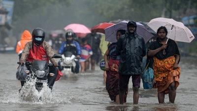 People wade through a flooded street after heavy monsoon rains in Chennai. (AFP) People wade through a flooded street after heavy monsoon rains in Chennai. (AFP)