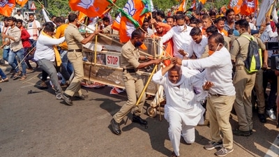 Police stops a BJP youth activists during a protest against the visit of Odisha CM Naveen Pattnaik to Kalahandi to enquire into the alleged case of murder of Mamita Meher. (PTI)