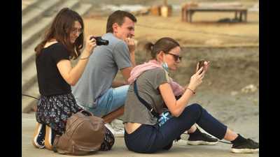 Foreign tourists at a Varanasi ghat. (HT photo)