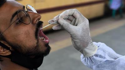 A BMC health worker collects a swab sample for a Covid-19 test in Mumbai on October 29 (Photo used for representational purpose only). (Satish Bate/HT photo) A BMC health worker collects a swab sample for a Covid-19 test in Mumbai on October 29 (Photo used for representational purpose only). (Satish Bate/HT photo)