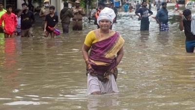 People wade through a flooded street after heavy rain in Chennai on November 7, 2021. Tamil Nadu is likely to see heavy rainfall for four more days. (AFP) People wade through a flooded street after heavy rain in Chennai on November 7, 2021. Tamil Nadu is likely to see heavy rainfall for four more days. (AFP)
