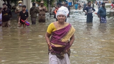 People wade through a flooded street after heavy rain in Chennai. (AFP) People wade through a flooded street after heavy rain in Chennai. (AFP)
