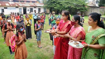 A file photo of teachers welcoming primary schoolchildren as Karnataka allowed the reopening of schools, in Chikmagalur. (PTI/File)