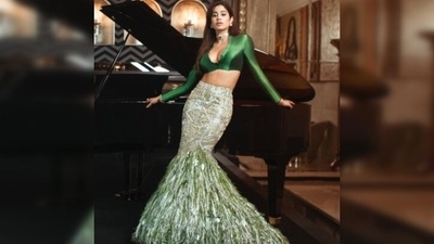 Janhvi Kapoor, in her recent Instagram picture, posed like a boss lady in a green satin crop top and mermaid shaped embellished skirt by ace designer Manish Malhotra. (Instagram/@janhvikapoor) Janhvi Kapoor, in her recent Instagram picture, posed like a boss lady in a green satin crop top and mermaid shaped embellished skirt by ace designer Manish Malhotra. (Instagram/@janhvikapoor)
