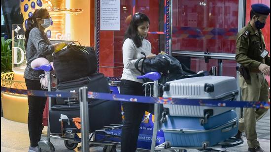 Passengers wait in a queue at the Terminal 3 of the IGI Airport to board a flight for the US, in New Delhi, on Sunday. All non-American and non-immigrant travellers will be required to show proof of Covid-19 vaccination before airlines will let them to board US-bound flights. (PTI)