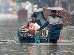 People wade through a flooded street after rainfall in Chennai.(AFP Photo) People wade through a flooded street after rainfall in Chennai.(AFP Photo)