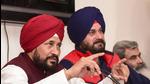 Punjab chief minister Charanjit Singh Channi with state Congress chief Navjot Singh Sidhu addresses a press conference in Chandigarh on Tuesday. (PTI) Punjab chief minister Charanjit Singh Channi with state Congress chief Navjot Singh Sidhu addresses a press conference in Chandigarh on Tuesday. (PTI)