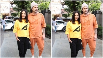 Sunny Leone's husband Daniel Weber, on the other hand, rocked in an orange hoodie and joggers set. (HT Photo/Varinder Chawla) Sunny Leone's husband Daniel Weber, on the other hand, rocked in an orange hoodie and joggers set. (HT Photo/Varinder Chawla)