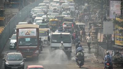 A worker sprinkles water on the road at Azadpur in New Delhi on Tuesday to curb dust pollution. (Sanchit Khanna/HT photo) A worker sprinkles water on the road at Azadpur in New Delhi on Tuesday to curb dust pollution. (Sanchit Khanna/HT photo)