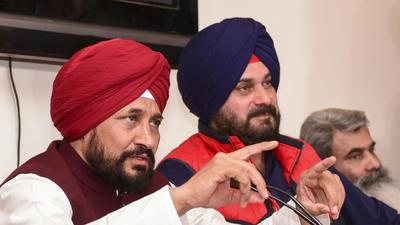 Punjab chief minister Charanjit Singh Channi with state Congress chief Navjot Singh Sidhu addresses a press conference in Chandigarh on Tuesday. (PTI) Punjab chief minister Charanjit Singh Channi with state Congress chief Navjot Singh Sidhu addresses a press conference in Chandigarh on Tuesday. (PTI)
