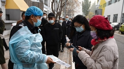 People scanning a QR code to register before getting a Covid-19 coronavirus test in Beijing. (AFP) People scanning a QR code to register before getting a Covid-19 coronavirus test in Beijing. (AFP)