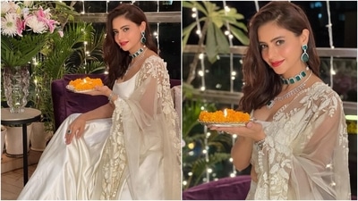 Aamna chose an emerald choker necklace, a diamond necklace with an emerald pendant, and emerald earrings to accessorise the white ensemble. Bold red lip shade, side-parted mane, and minimal make-up completed her glam. If you're looking for a minimal, lightweight white attire for attending a ceremony during your wedding, Aamna's lehenga is a good option. (Instagram/@aamnasharifofficial)
