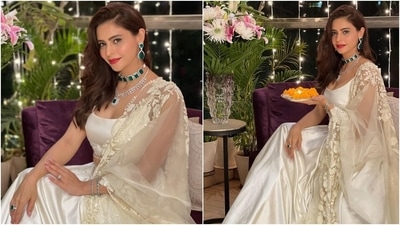 The pristine white lehenga set Aamna chose to wear for the celebrations is from the clothing label Prémya by Manishii. It features a spaghetti-strapped blouse with a low neckline, beaded tassel embroidery, and midriff-baring hem. She teamed the short choli with a matching silk lehenga adorned with diamantes all over. (Instagram/@aamnasharifofficial)