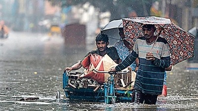 People wade through a flooded street after rainfall in Chennai. (AFP Photo) People wade through a flooded street after rainfall in Chennai. (AFP Photo)