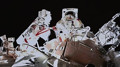 Chinese astronaut Wang Yaping steps out from Tiangong space station's Tianhe core module. (AP) Chinese astronaut Wang Yaping steps out from Tiangong space station's Tianhe core module. (AP)