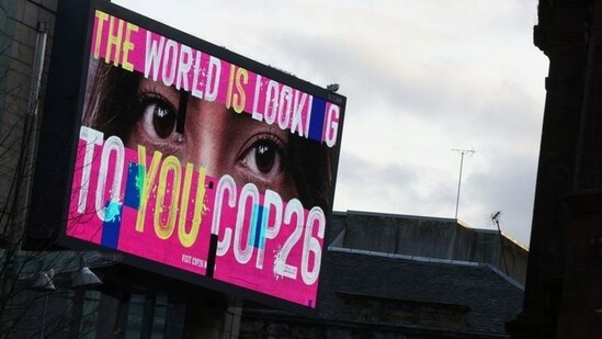 An advertising board is seen during the UN Climate Change Conference (COP26) in Glasgow, Scotland on November 7, 2021. (REUTERS)