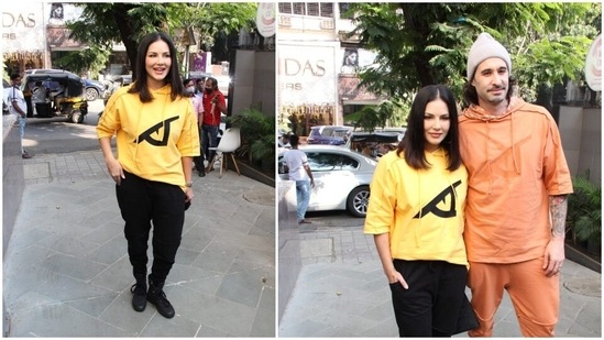 Sunny Leone parted her hair in the middle and left it open. Daniel Weber accessorised his look with a neutral beanie.(HT Photo/Varinder Chawla)