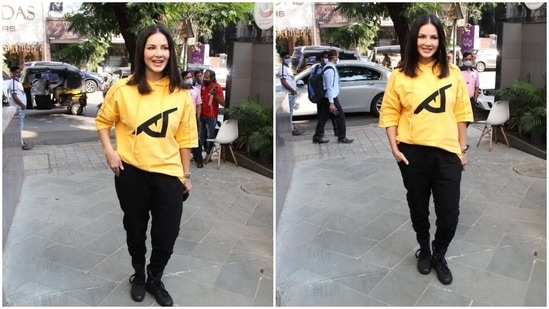 Sunny Leone wore a yellow hoodie which she teamed with black joggers and boots.(HT Photo/Varinder Chawla)
