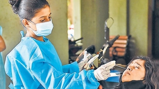 A health worker collects swab sample of a resident for a Covid-19 test in Mumbai. (PTI/File)