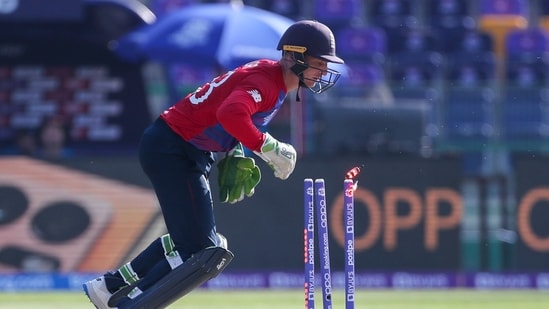 England's Jos Buttler runs out Bangladesh's Afif Hossain during the Cricket Twenty20 World Cup match between England and Bangladesh in Abu Dhabi, UAE, Wednesday, Oct. 27, 2021.(AP)