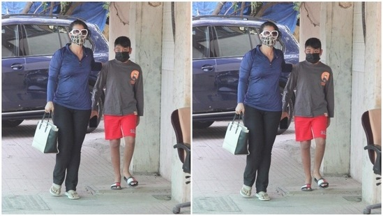 Kajol sported a blue jacket and a pair of black trousers, while Yug went all casual in a grey tee shirt and a pair of red shorts.(HT Photos/Varinder Chawla)