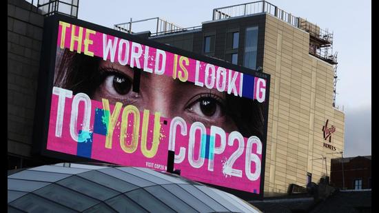 An advertising board is seen during the UN Climate Change Conference (COP26), Glasgow, Scotland, November 7, 2021 (REUTERS)