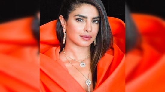 Priyanka Chopra is elegance personified in this stunning orange blazer dress with draped shawl cape and patch pockets.(Instagram/@priyankachopra)