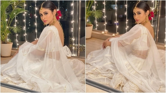 Sharing several pictures of herself wearing the voguish and classy white lehenga set, Mouni wrote, "For the love of white." Her organza attire is a perfect pick for those looking for an ethereal festive look to turn heads at any event or while attending your best friend's wedding festivities. We also found the price of the ethnic set, so scroll on to find out.(Instagram/@imouniroy)