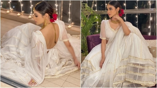 Mouni glammed up her all-white look with a gold choker necklace, matching earrings, and a mang tika. She also tied her locks in a middle-parted sleek bun - adorned with roses - giving her festive look an old-world touch. In the end, kohl-adorned eyes, blush pink lipstick, and glowing skin completed her beauty picks.(Instagram/@imouniroy)