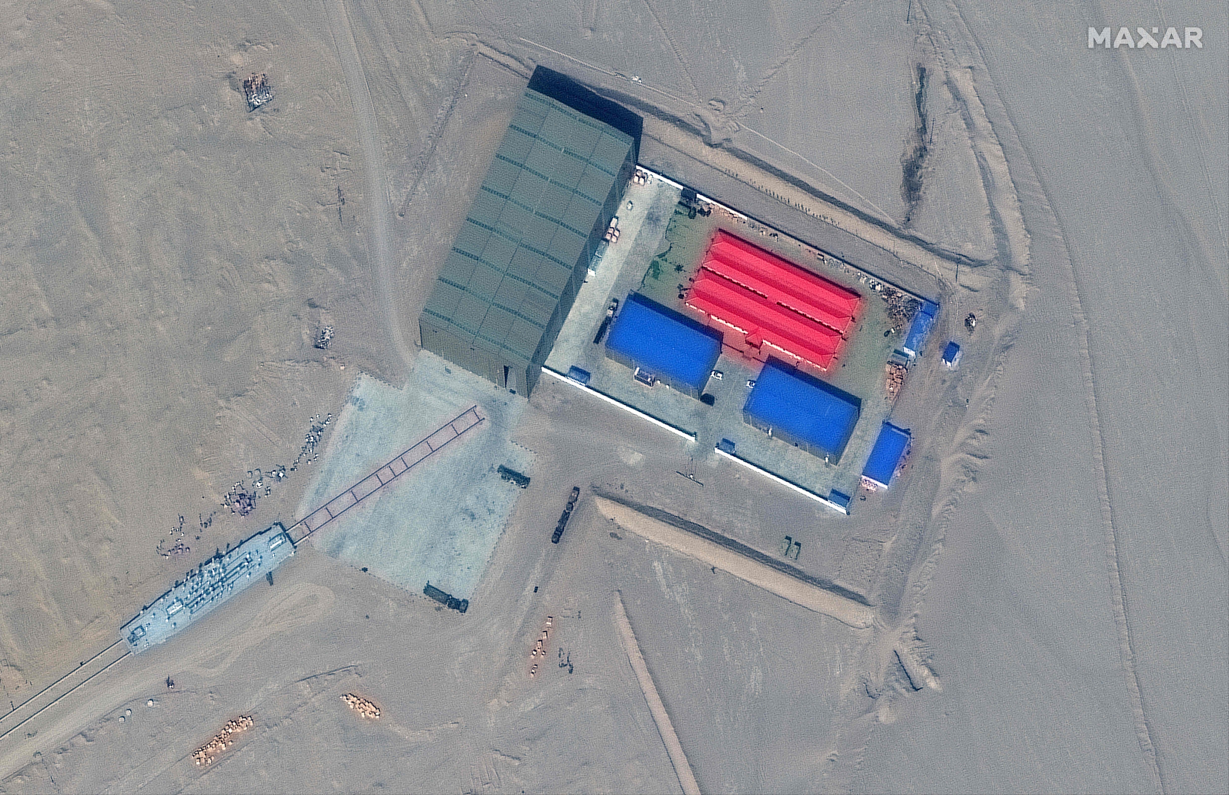 This handout satellite image released by Maxar Technologies shows a rail terminus and a target storage building in Ruoqiang county in the Taklamakan Desert.(AFP Photo)