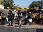 Taliban fighters stand as they hold a checkpoint in Kabul, Afghanistan.